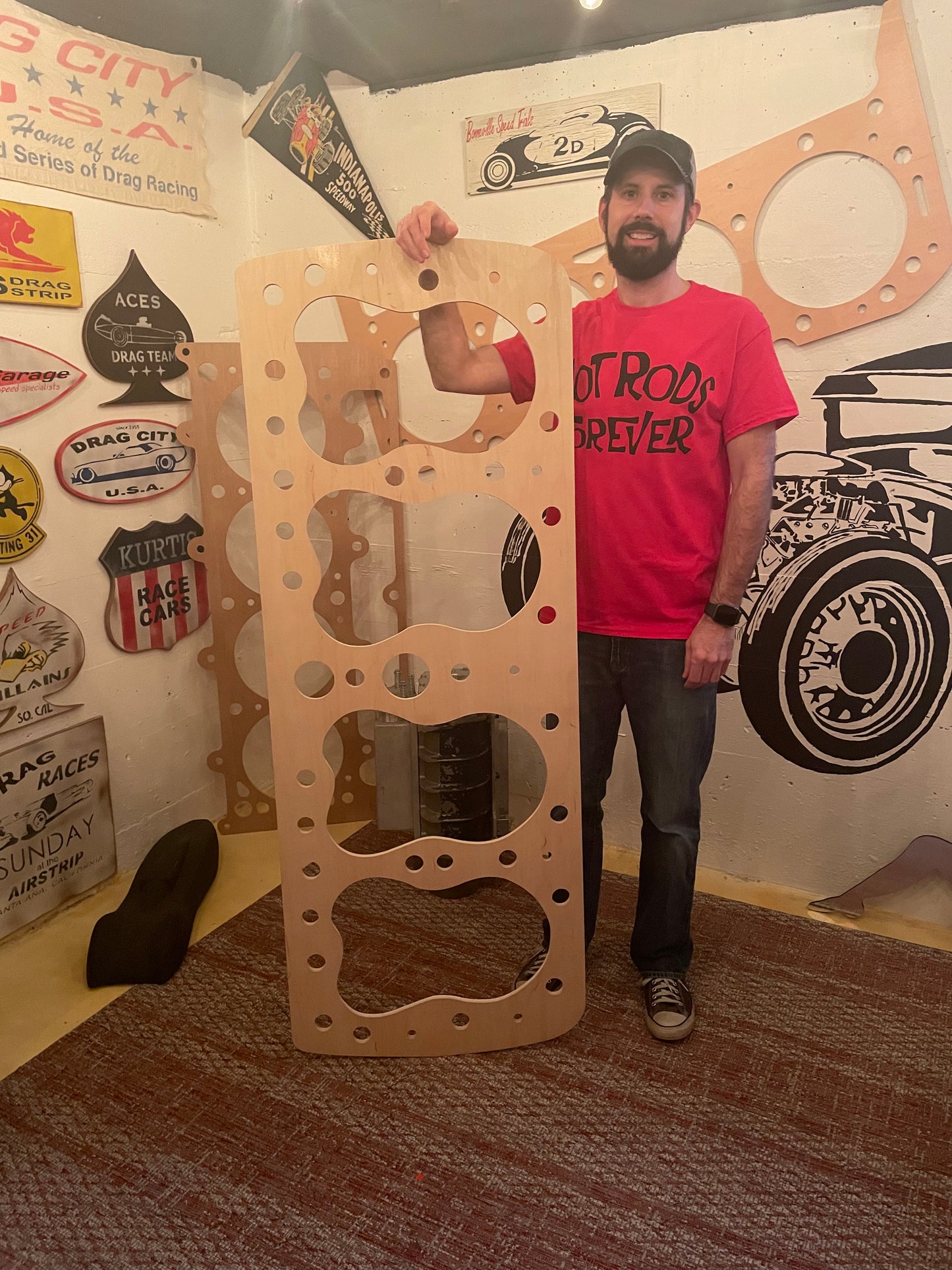 Rod Shop Collective founder standing next to a giant five foot handmade wooden flathead Ford head gasket — Hand Built collection — Louisville, Kentucky