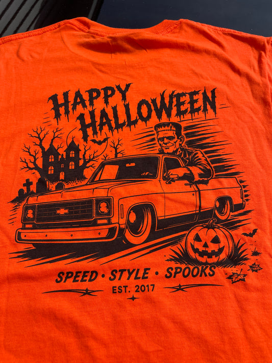 Back print detail of Frankenstein in a lowered squarebody Chevy C10 past a haunted house, hand screen printed in black on orange, Rod Shop Collective, Louisville KY