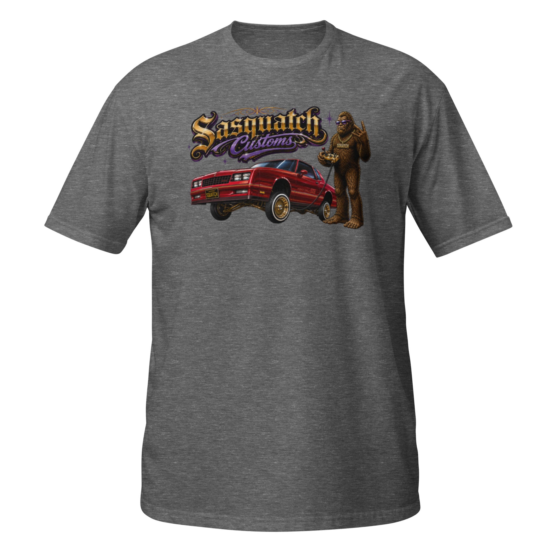 Sasquatch Customs Lowrider Series t-shirt — Bigfoot hitting the switches next to a 1987 Monte Carlo with hydraulics and gold Dayton wire wheels — funny Sasquatch lowrider tee on graphite — Rod Shop Collective