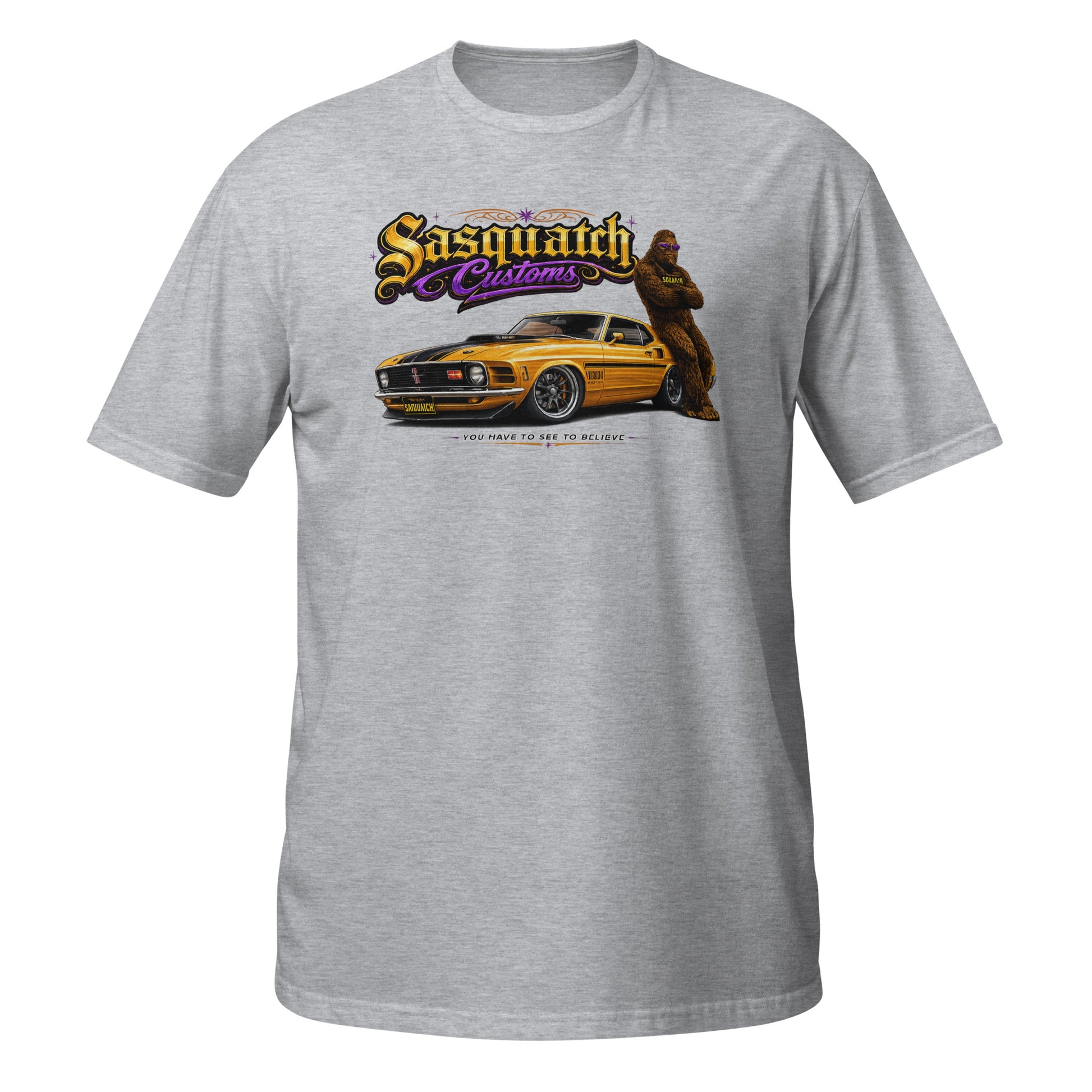 Sasquatch Customs Muscle Car Collection t-shirt — Bigfoot leaning on a 1970 Mustang Mach 1 pro-touring build on billet wheels with arms crossed — funny Sasquatch muscle car tee on gray — Rod Shop Collective