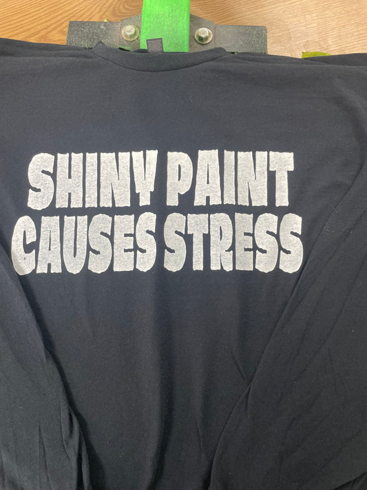 Black long sleeve shirt with hand screen printed Shiny Paint Causes Stress design in white ink