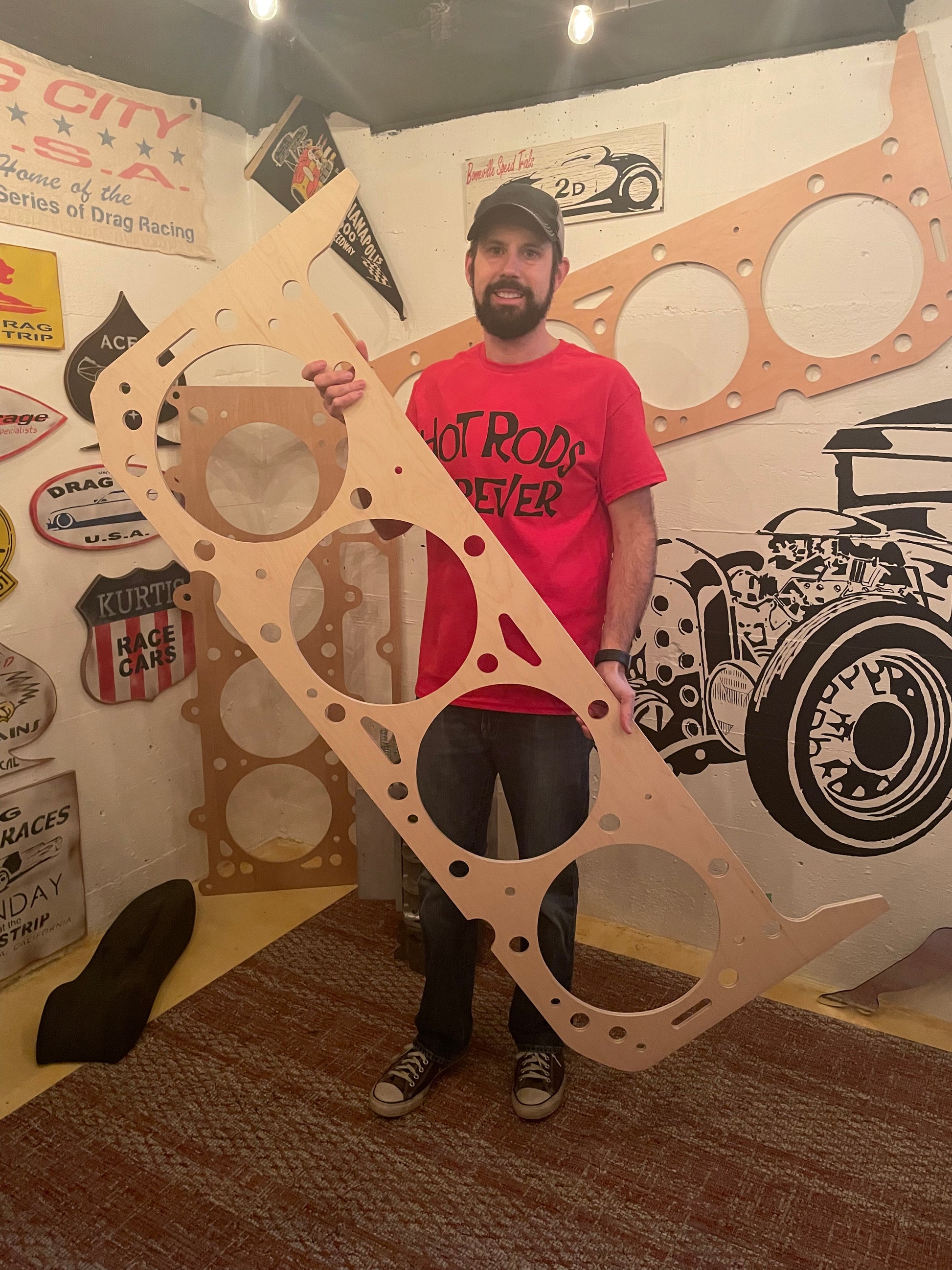 Rod Shop Collective founder standing next to a giant five foot handmade wooden small block chevy head gasket — Hand Built collection — Louisville, Kentucky